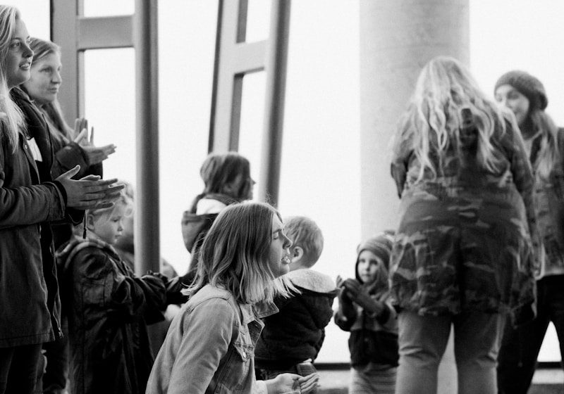 grayscale photo of people walking on hallway